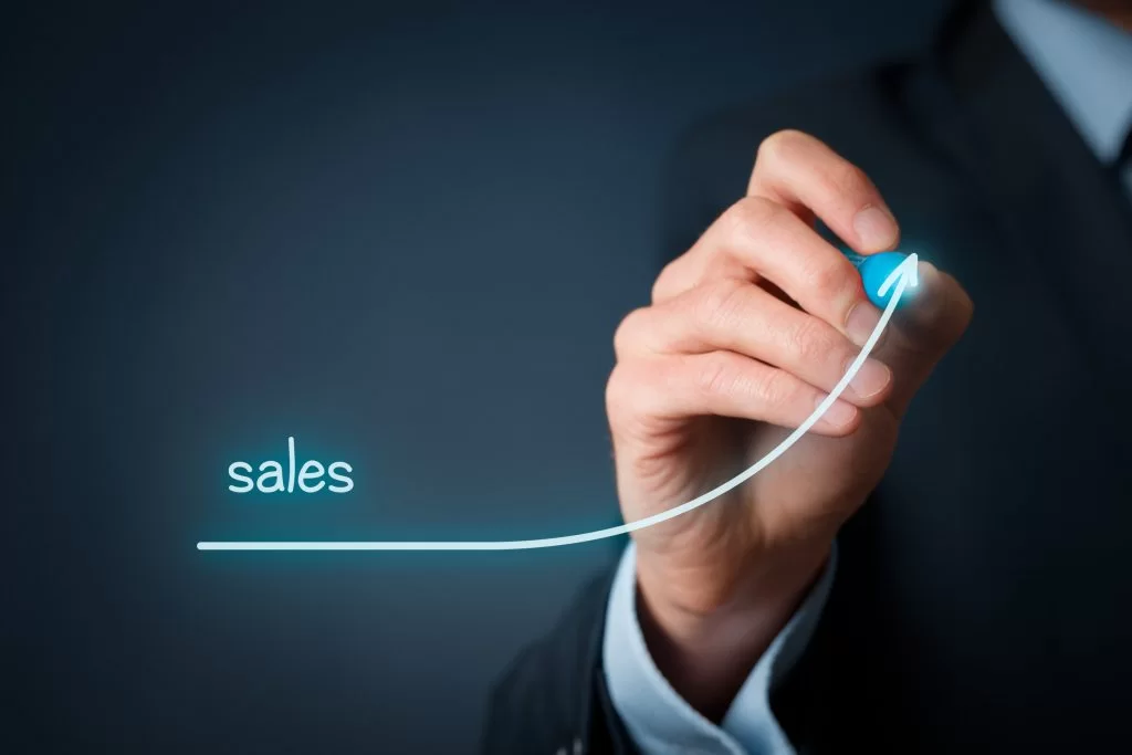 Businessman drawing a rising arrow